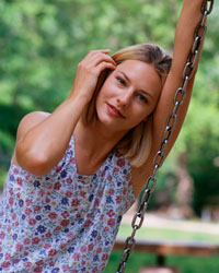 Picture of a young woman sitting on a swing